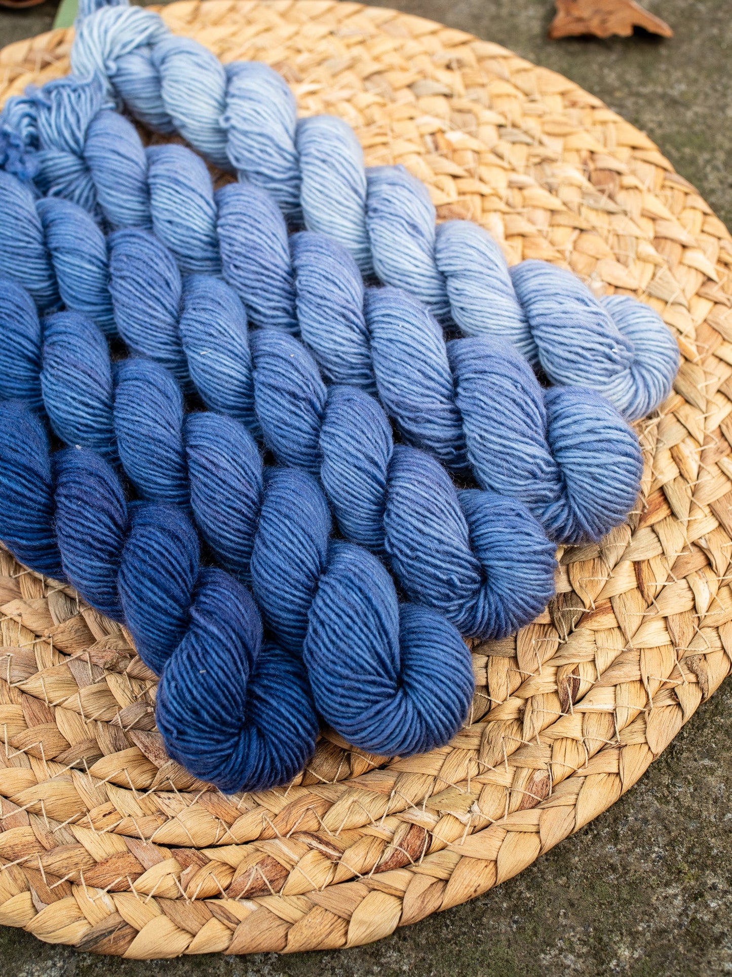 5 mini skeins of hand dyed yarn in a gradient/fade set in color denim blue.