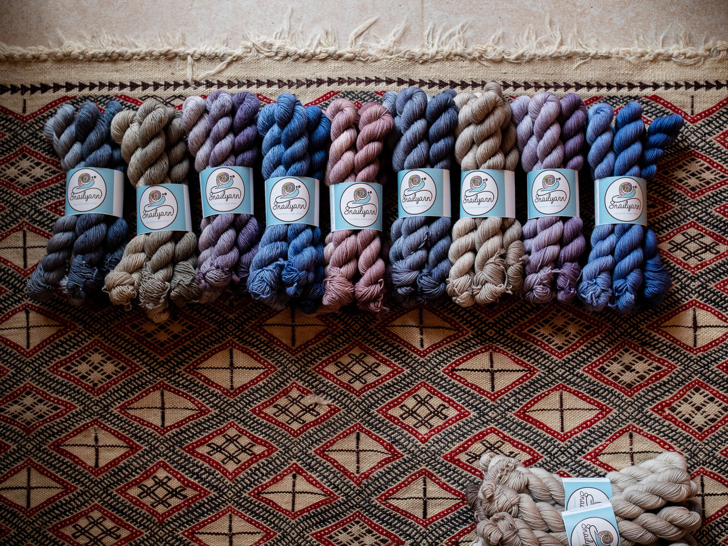 A group of hand dyed fade yarn grouped in mini skein bundles and showed in multiple colors.