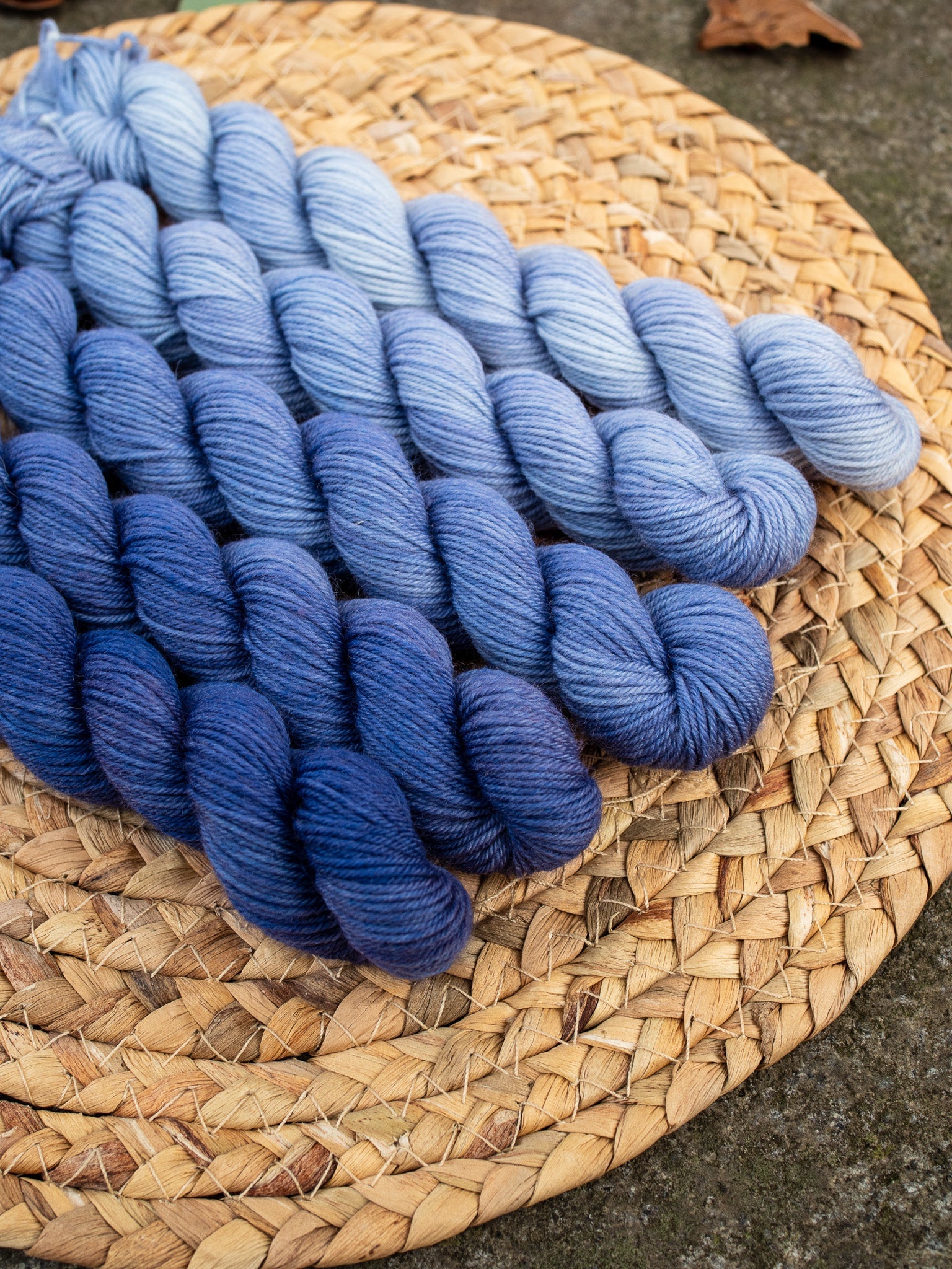 5 mini skeins of hand dyed yarn in a gradient/fade set in color denim blue.