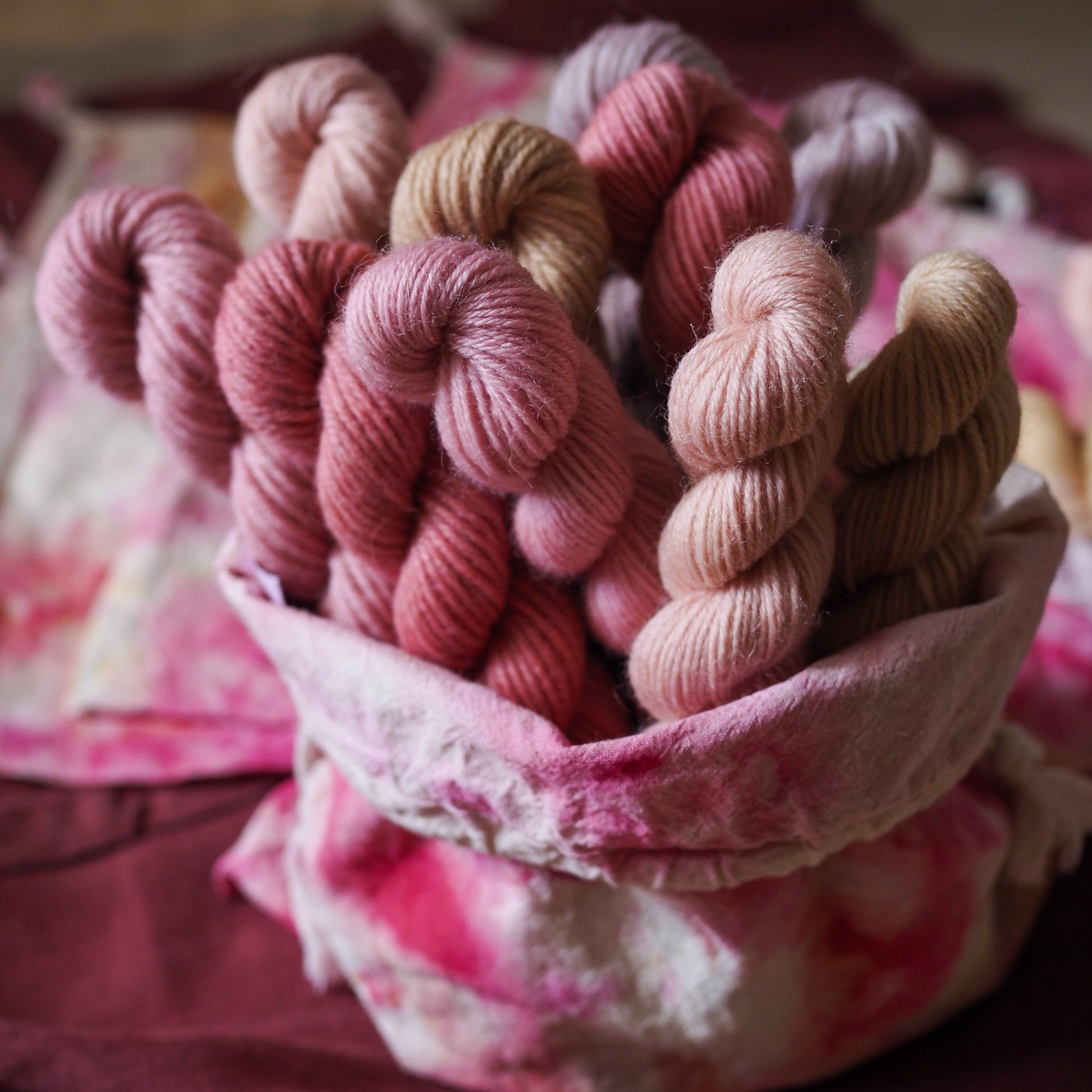 Hand-dyed 5 mini-skein yarn set by Snail Yarn in botanical shades of dusty pink, peach, and mauve, inspired by English roses. High-quality Merino and Peruvian wool for knitting and colorwork.