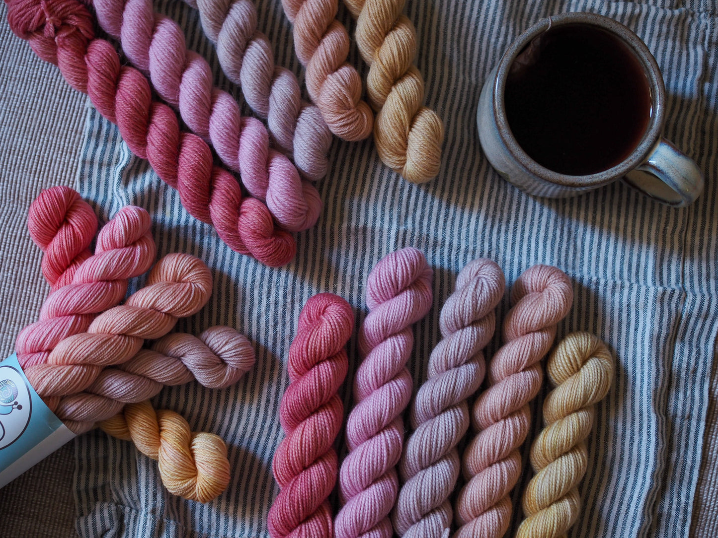 Hand-dyed 5 mini-skein yarn set by Snail Yarn in botanical shades of dusty pink, peach, and mauve, inspired by English roses. High-quality Merino and Peruvian wool for knitting and colorwork.