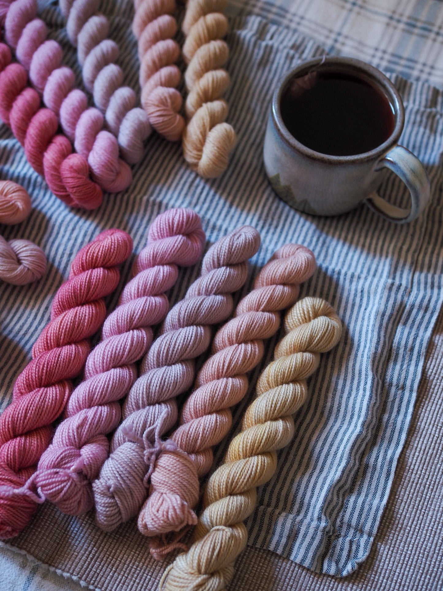 Hand-dyed 5 mini-skein yarn set by Snail Yarn in botanical shades of dusty pink, peach, and mauve, inspired by English roses. High-quality Merino and Peruvian wool for knitting and colorwork.